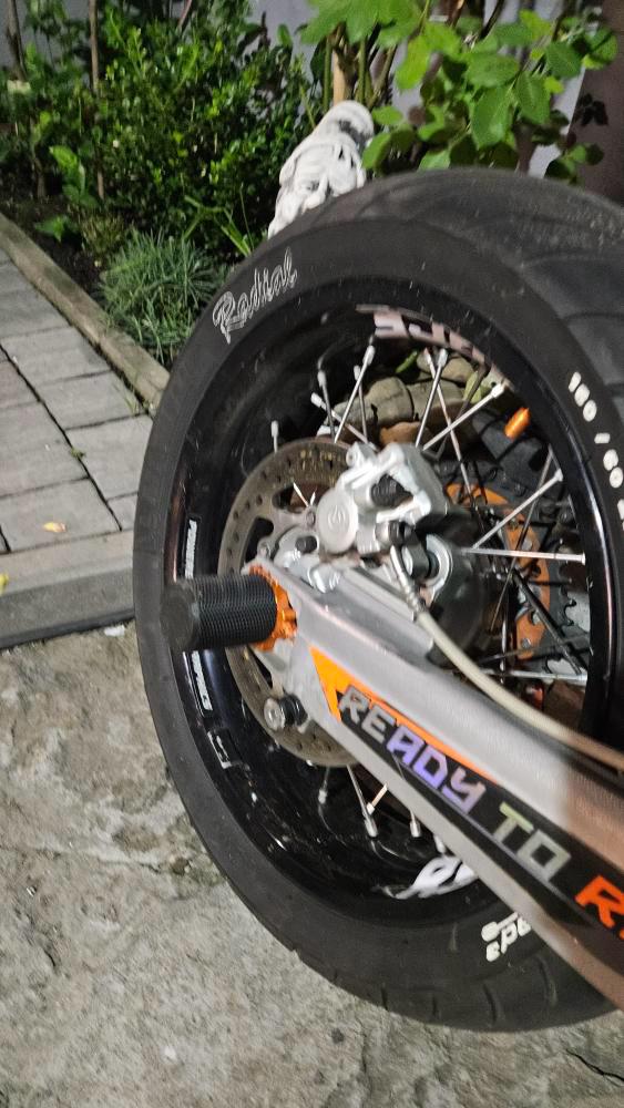 Close-up of a bicycle wheel with visible brand name on a concrete surface.